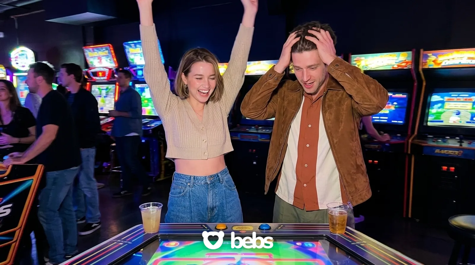 Woman celebrating a win against her date at an arcade bar, a playful second date idea